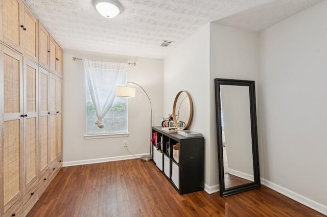 2277 Lazy Days Rd, Dacula, GA 30019 - bedroom featuring dark wood finished floors, baseboards, and a textured ceiling