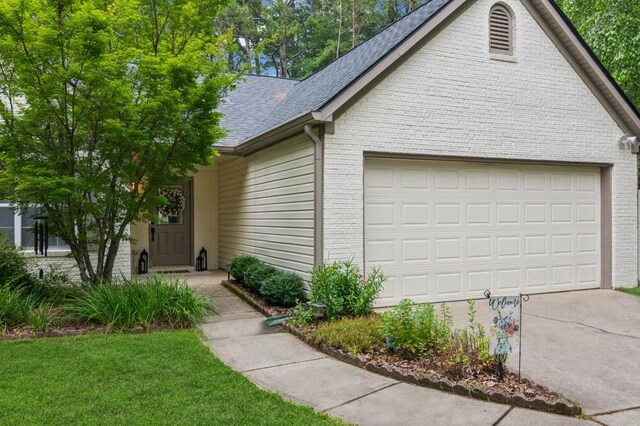 2277 Lazy Days Rd, Dacula, GA 30019 - view of front facade with brick siding, concrete driveway, roof with shingles, and a garage