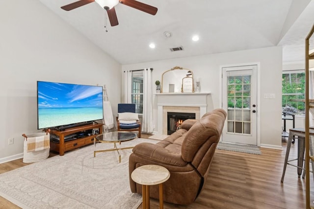 2277 Lazy Days Rd, Dacula, GA 30019 - living area with vaulted ceiling, a glass covered fireplace, wood finished floors, recessed lighting, and ceiling fan