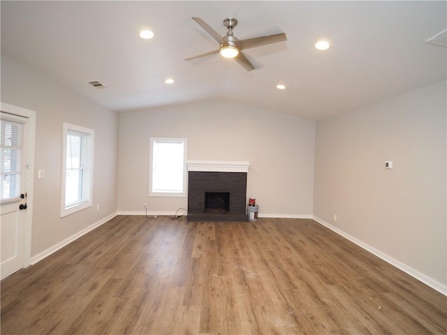 unfurnished living room featuring a fireplace, recessed lighting, visible vents, wood finished floors, and baseboards