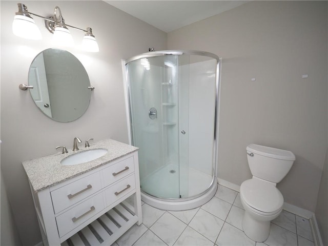 bathroom with toilet, a shower stall, vanity, and baseboards