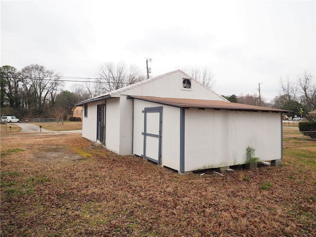 view of outbuilding with an outbuilding and fence