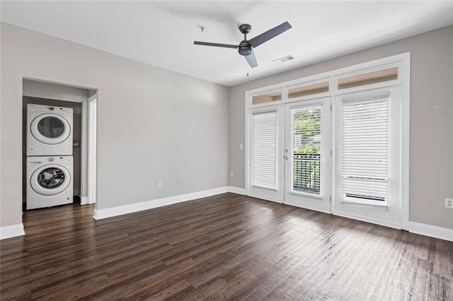 840 United Ave SE Unit 401, Atlanta, GA 30312 - empty room featuring estacked washer and dryer, a ceiling fan, dark wood finished floors, and baseboards