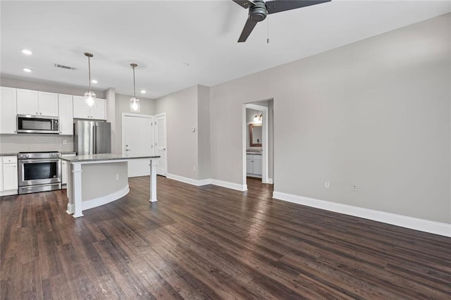 840 United Ave SE Unit 401, Atlanta, GA 30312 - kitchen featuring stainless steel appliances, a ceiling fan, a kitchen breakfast bar, baseboards, and white cabinetry