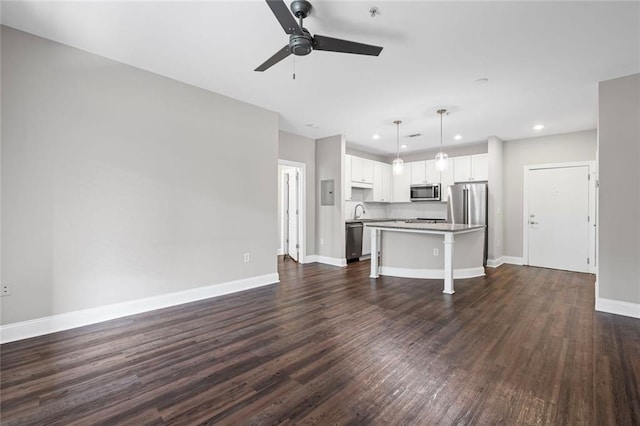 840 United Ave SE Unit 401, Atlanta, GA 30312 - unfurnished living room featuring ceiling fan, baseboards, dark wood finished floors, recessed lighting, and a sink