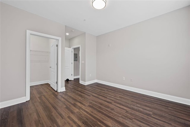 840 United Ave SE Unit 401, Atlanta, GA 30312 - unfurnished bedroom with dark wood-type flooring, baseboards, a walk in closet, a closet, and recessed lighting