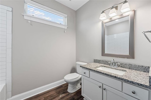 840 United Ave SE Unit 401, Atlanta, GA 30312 - bathroom featuring wood finished floors, vanity, toilet, and baseboards