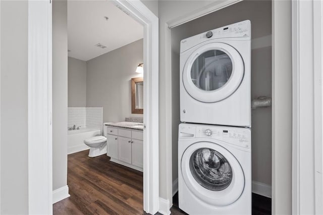 840 United Ave SE Unit 401, Atlanta, GA 30312 - laundry area featuring stacked washer / dryer and dark wood-style flooring
