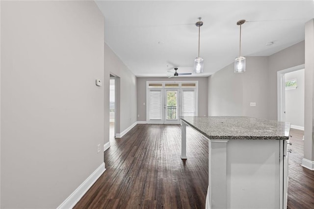 840 United Ave SE Unit 401, Atlanta, GA 30312 - kitchen featuring baseboards, dark wood-style flooring, open floor plan, a ceiling fan, and a kitchen island