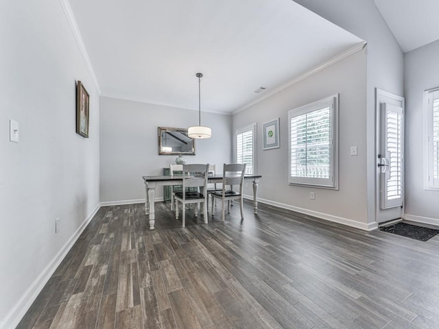 dining area featuring ornamental molding, dark wood finished floors, and baseboards