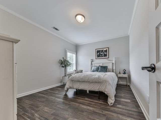 bedroom with crown molding, wood finished floors, and baseboards