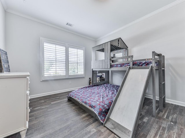bedroom featuring crown molding, wood finished floors, and baseboards