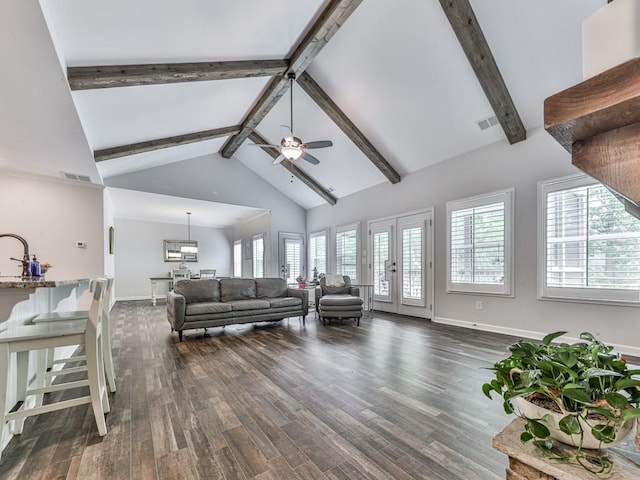 living room with ceiling fan, plenty of natural light, dark wood-style floors, beam ceiling, and high vaulted ceiling