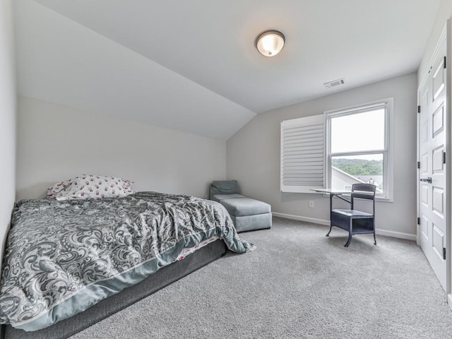 bedroom featuring baseboards, carpet flooring, and vaulted ceiling