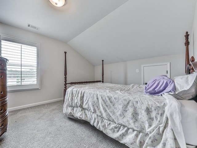 carpeted bedroom featuring vaulted ceiling and baseboards
