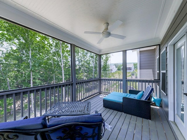 sunroom / solarium featuring a ceiling fan and an outdoor hangout area