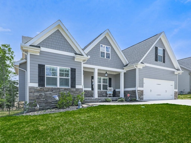 craftsman house featuring a porch, stone siding, an attached garage, and concrete driveway