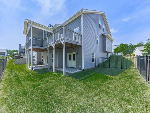 rear view of house featuring a deck, a patio area, and a sunroom