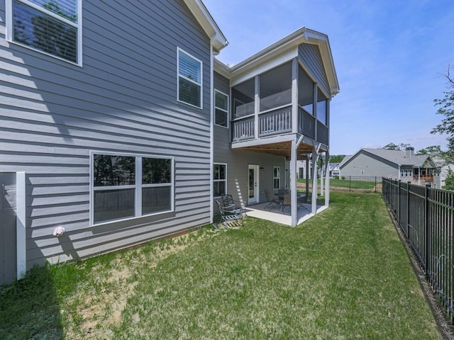 back of property featuring a patio area and a sunroom