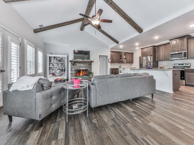 living room featuring a fireplace, dark wood-style floors, ceiling fan, and recessed lighting