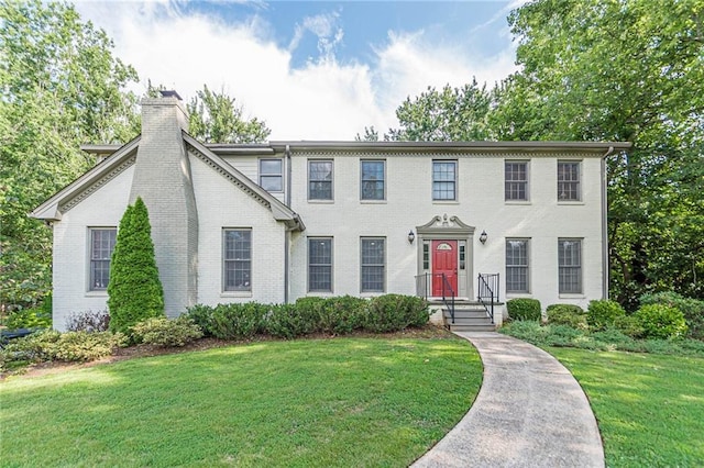 colonial-style house with a front yard