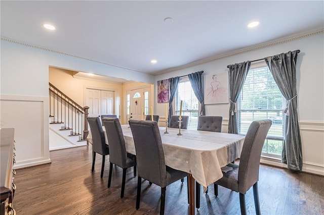 dining room featuring dark wood-type flooring and crown molding