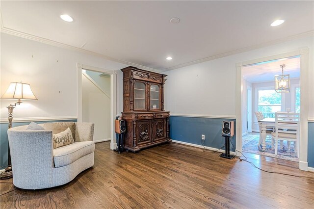 living room with dark wood-type flooring, crown molding, decorative columns, and a brick fireplace