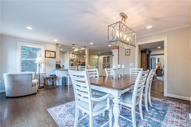 dining area featuring dark hardwood / wood-style flooring and ornamental molding