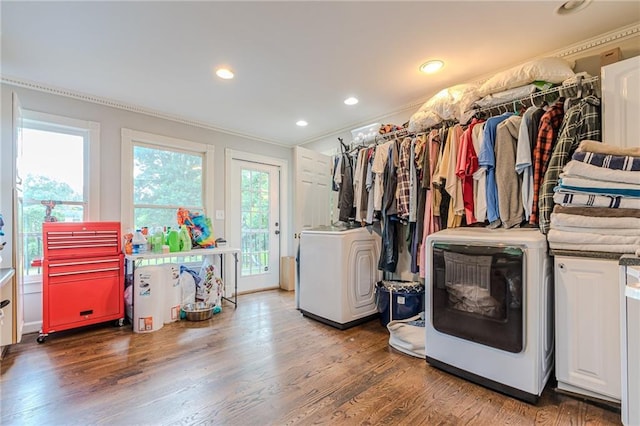 interior space featuring ornamental molding, dark wood-type flooring, and washer / dryer