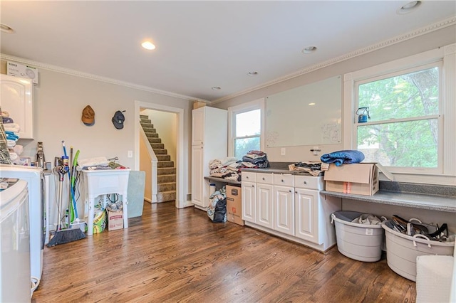 clothes washing area with a healthy amount of sunlight, separate washer and dryer, crown molding, and dark hardwood / wood-style flooring