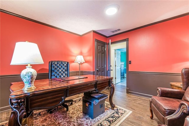 home office featuring ornamental molding and wood-type flooring