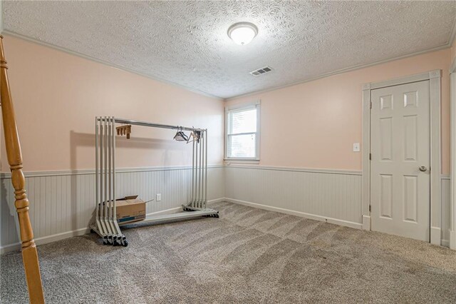 bathroom with toilet, ornamental molding, and walk in shower