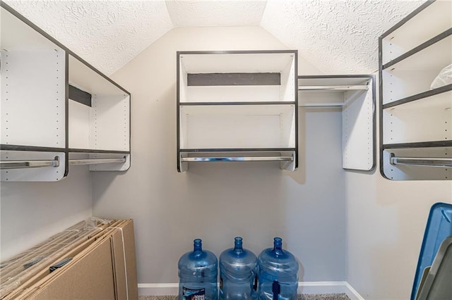 clothes washing area with a textured ceiling