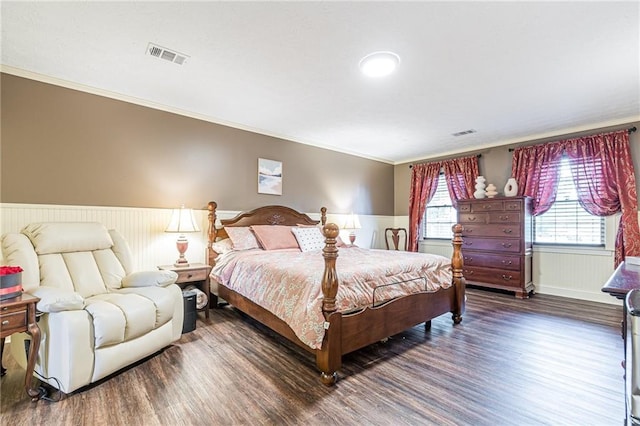 bedroom featuring crown molding and dark hardwood / wood-style floors