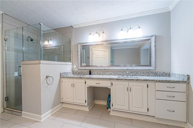 bathroom with ornamental molding, vanity, an enclosed shower, and a textured ceiling