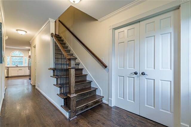 entryway featuring crown molding and dark hardwood / wood-style floors