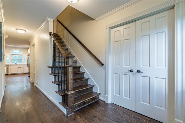 stairway featuring hardwood / wood-style floors and crown molding