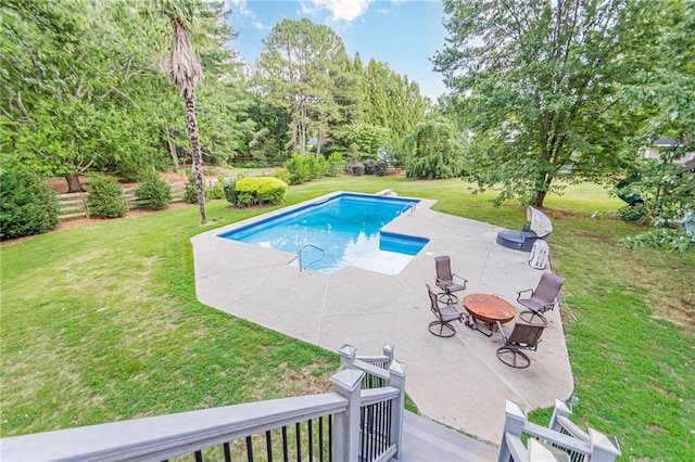 view of swimming pool featuring a patio, a lawn, and an outdoor fire pit