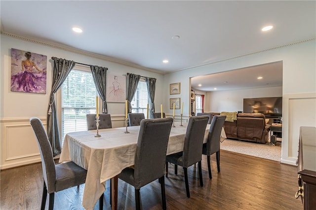 dining space featuring ornamental molding and dark wood-type flooring