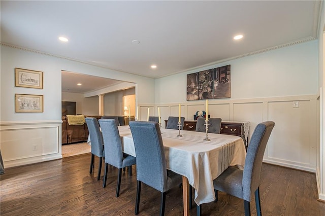 dining space featuring ornamental molding and dark wood-type flooring