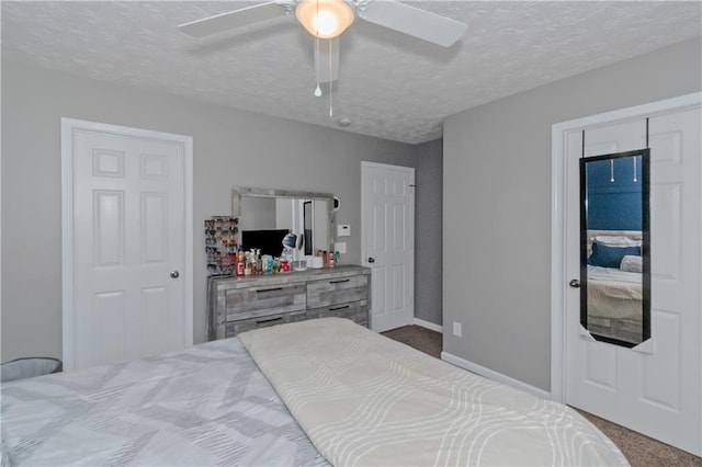 carpeted bedroom featuring a textured ceiling and ceiling fan