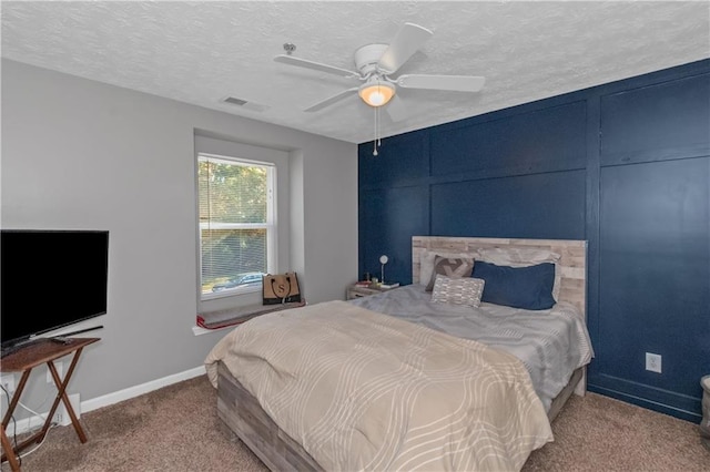 bedroom with carpet, ceiling fan, and a textured ceiling