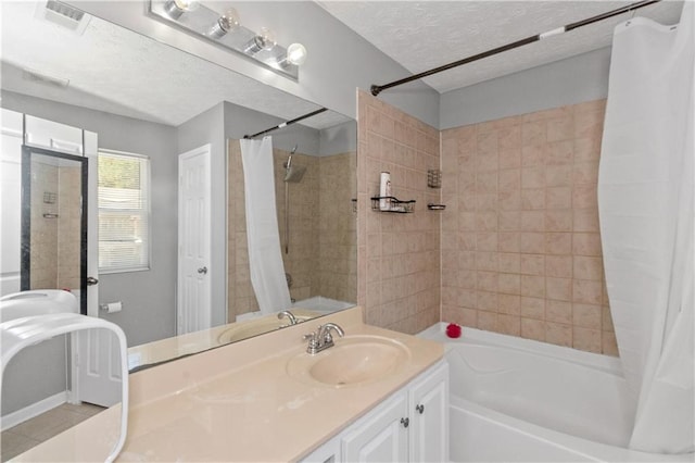 bathroom with tile patterned flooring, shower / bath combo, a textured ceiling, and vanity