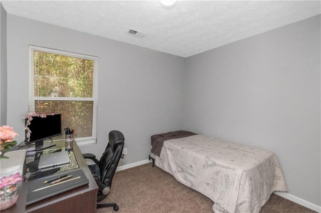 bedroom with carpet flooring and a textured ceiling