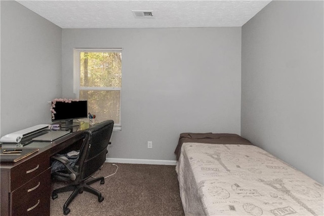 carpeted bedroom with a textured ceiling