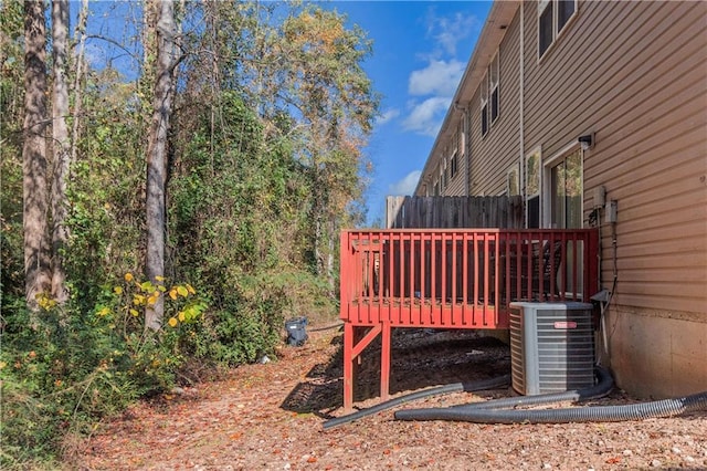 view of yard featuring a wooden deck and central AC unit