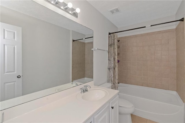 full bathroom with vanity, tile patterned floors, toilet, shower / bathtub combination with curtain, and a textured ceiling