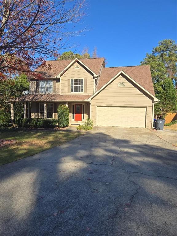 traditional-style house with an attached garage and driveway