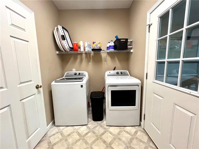 clothes washing area featuring washer and dryer, laundry area, and light floors