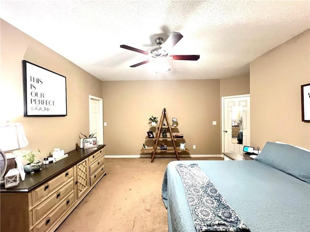 bedroom featuring baseboards, a textured ceiling, ceiling fan, and light colored carpet